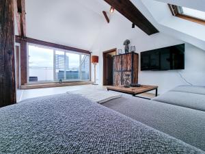 a bedroom with a large bed and a large window at Alpha Apartments in Essen