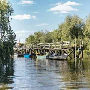a group of boats docked next to a wooden bridge at Casa Lusitano by Valada Village in Valada