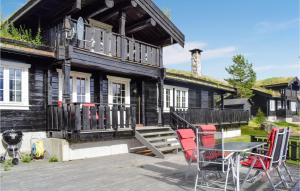 a house with a table and chairs in front of it at Lovely Home In Treungen With Wifi in Treungen