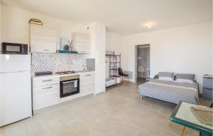 a kitchen with a refrigerator and a couch in a room at Lovely Apartment In Piana With Wifi in Piana