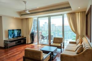 a living room with a couch and a tv at Brand new Water Front Luxury Cinnamon Suites Apartment in heart of Colombo City in Slave Island