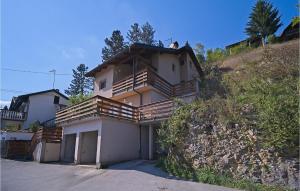 a house with wooden balconies on the side of a hill at Awesome Home In Donji Zvecaj With Wifi in Donji Zvečaj