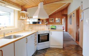 a kitchen with white cabinets and a sink at Stunning Home In Humble With 4 Bedrooms, Sauna And Wifi in Humble
