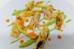 a white plate of food with fish and vegetables at Hotel Mirasole International in Gaeta