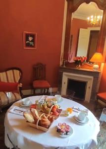 a table with a tray of bread and fruit on it at Château Maucaillou in Moulis-en-Médoc