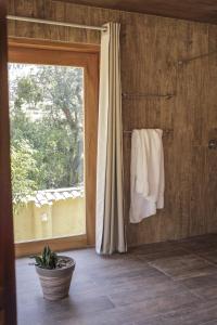 a bathroom with a window and towels on a wall at Casafranca in Ollantaytambo