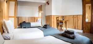 a hotel room with two beds with towels on them at Nant Morzine in Morzine