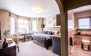 a hotel room with a bed and a dining room at Eton House - Self Check-In Serviced Studios & Rooms in Yeovil