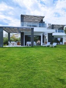 a large house with a lawn in front of it at Lux et Mare in Pefkochori