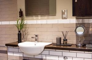 a bathroom with a white sink and a mirror at Eton House - Self Check-In, Ensuite Rooms & Self-Catering Studios in Yeovil +83 photos