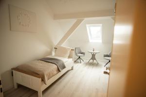 a bedroom with a bed and a table with chairs at Landgut Rastede Hostemost in Rastede