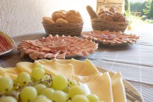 a table with plates of food and baskets of bread at Pension Bernhard in Landl +21 photos