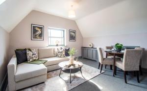a living room with a couch and a table at Eton House - Self Check-In, Ensuite Rooms & Self-Catering Studios in Yeovil