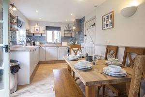 a kitchen with a wooden table and a dining room at Mill Village 68, Somer House - P in Somerford Keynes
