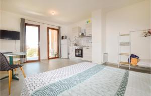 a white bedroom with a bed and a desk at Beautiful Apartment In Piana With Wifi in Piana