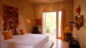 a bedroom with a bed and a sliding glass door at Asnouss in Marrakech