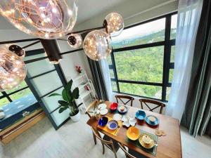 a dining room with a table and a large window at Mango House6-High floor I Biggest unit I SeaView I Waterfilte I Wifi-JQ in Kota Kinabalu