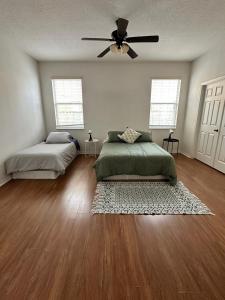 a bedroom with two beds and a ceiling fan at Close to Disney. Big house with backyard in Orlando