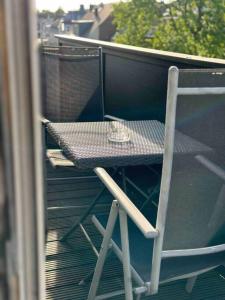 a table and a chair on a balcony at Appartement in MG City Self- Check-in in Mönchengladbach