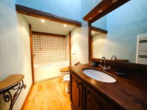 a bathroom with a sink and a toilet and a mirror at Hostdomus - Imperial Chalet in Sestriere