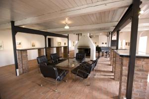 a room with a table and chairs and a fireplace at Ängavallen in Vellinge