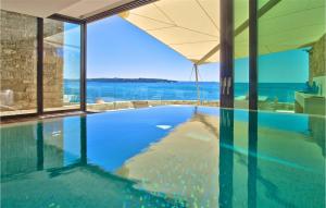 a swimming pool with a view of the ocean at Villa Lorena in Novigrad Istria