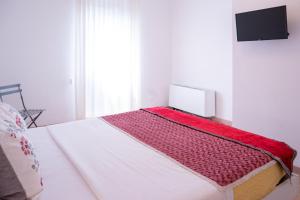 a bedroom with a bed with a red blanket on it at Ca' Popolo Venice in Mestre