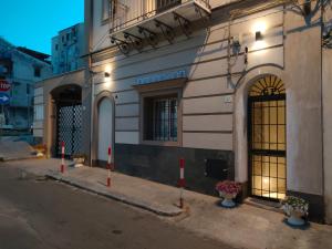 a building with red poles in front of a building at CASA VACANZA NORMANNI in Palermo