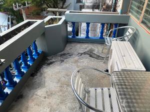 a patio with two chairs and a bench on a building at Riviera Beach in Pattaya
