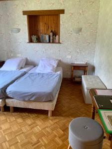um quarto com 2 camas e uma mesa em Dormez dans la chambre du meunier ! em Germolles-sur-Grosne