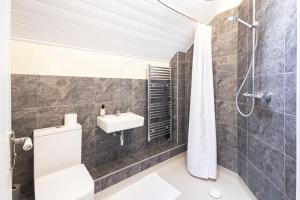 a bathroom with a toilet and a sink at Spring Lake 19, The Lake House in South Cerney