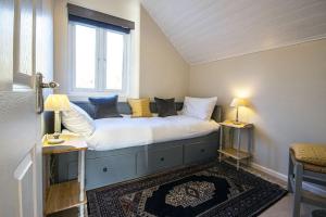 a bed in a room with a window at Spring Lake 19, The Lake House in South Cerney