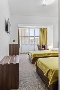Postel nebo postele na pokoji v ubytování Lina Hotel