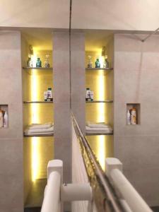 a bathroom with gold shelves with towels on them at Dream Tower in Międzybrodzie Bialskie