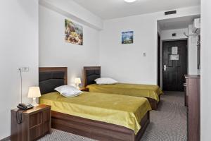 Postel nebo postele na pokoji v ubytování Lina Hotel