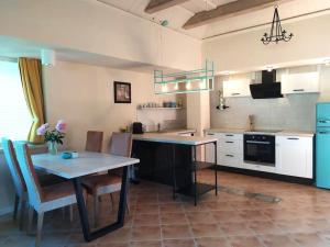 a kitchen with a table and some chairs and a table and a counter at Dream Tower in Międzybrodzie Bialskie