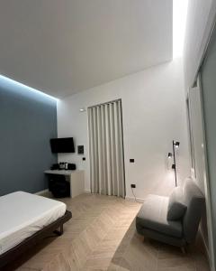 1 dormitorio con 1 cama, 1 silla y TV en Central Suite 81 en Pescara