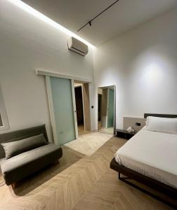 a bedroom with a bed and a couch in it at Central Suite 81 in Pescara