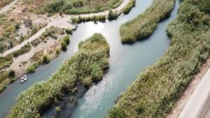 an aerial view of a river with trees and a boat at Layla Glamping in Nir Dawid
