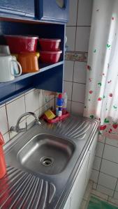 a kitchen counter with a sink in a kitchen at Big Hostel Brasil in Manaus