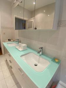 a bathroom with two sinks and a large mirror at Elegance ,Space & Luxury in Brussels in Brussels