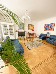 a living room with a blue couch and a table at Elegance ,Space & Luxury in Brussels in Brussels