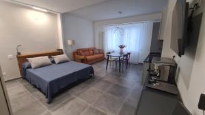 a bedroom with a bed and a chair and a table at Appartamentino In Piazza in Grottammare