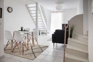 a living room with a table and chairs at Le Beauvoir in Saint-Marcellin