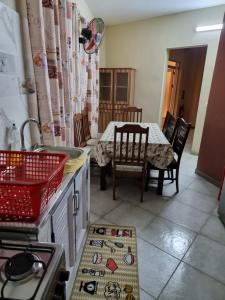 a kitchen with a table and chairs and a table and a table at Eleganz Residence in Grand Baie