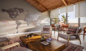 a living room with a map of the world on the wall at Wanderlust in Campos do Jordão