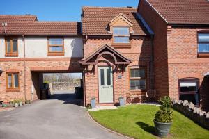 a brick house with a white door and a driveway at Fairburn - DayDream Stays, luxury accomodation for holidays and contractors in Fairburn