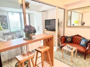 a living room with a couch and a table at Azure staycation by jane in Manila