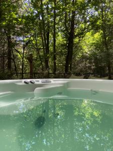 a bath tub with trees in the background at Locanda Milia in Ragalna