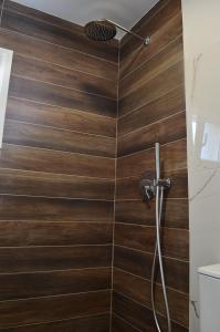 ein Badezimmer mit Dusche mit Holzfliesen in der Unterkunft KooKai - Luxury Living in Peraia + 13 Fotos